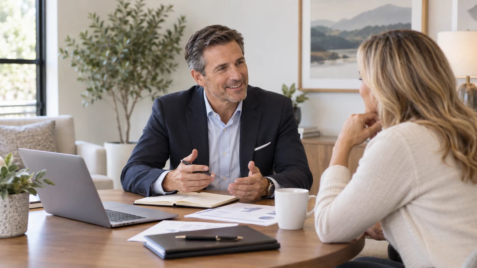 An adviser and client in conversation at a desk during a financial planning meeting